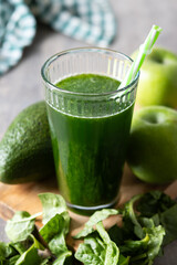 Green smoothie detox with Kale, avocado and apples on wooden table