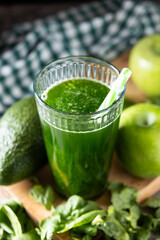Green smoothie detox with Kale, avocado and apples on wooden table