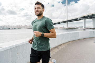 Runner exercise is hardy. The trainer is a sporty man in sportswear training running.  Motivation...