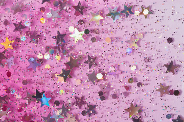Pink jelly background with glitter and shiny particles.