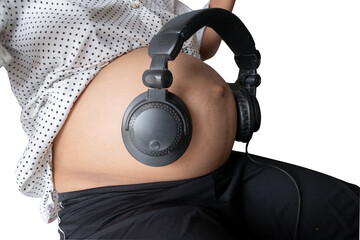 Pregnant woman holds headphones to her stomach