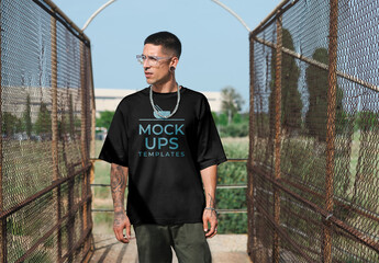 Mockup of man between wire fences wearing t-shirt with customizable