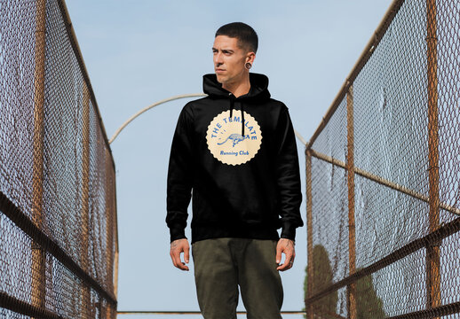 Mockup of man wearing hoodie with customizable between wire fences