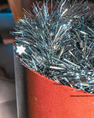 A silver tinsel garland inside a box. Close up. Christmas decoration