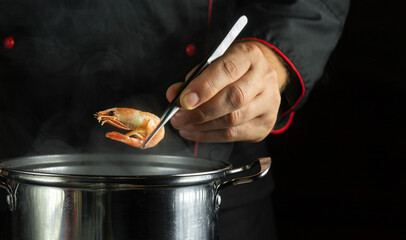 Cooking shrimp in a boiling pan. Delicious and healthy seafood. Boiled shrimp in a spoon or chef...