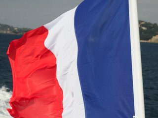 waving france tricolor flag on ferry to porquerolles island france panorama landscape
