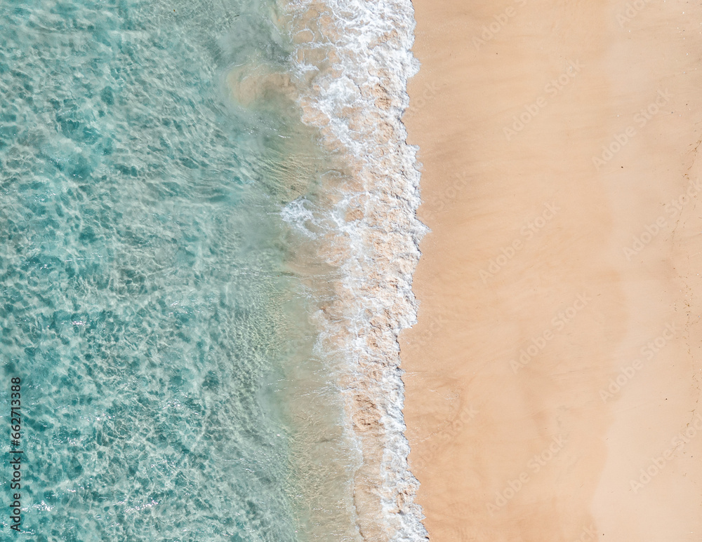 Wall mural aerial split view of the ocean and a beach