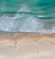 Aerial split view of the ocean and a beach