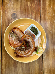 Crispy Roasted Pork Porchetta at plate on table.