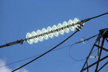 High voltage tower with electrical voltage wires isolates close-up against the background of...