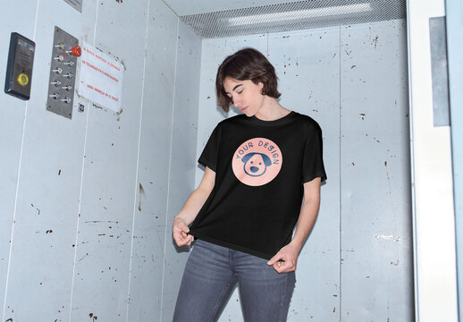 Mockup of young woman wearing customizable t-shirt in elevator, flash