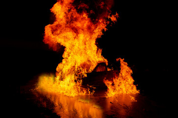 Fototapeta na wymiar fire in the fireplace, fireman with fire extinguisher.