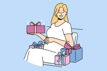 Pregnant woman with gift box strokes belly and looks at screen in anticipation of birth of baby. Pregnant girl is preparing to become mother and enjoys gifts from friends and relatives