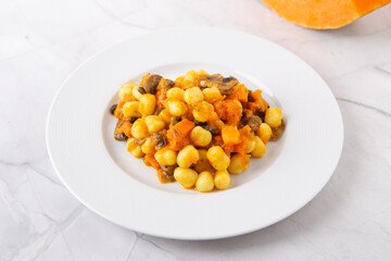 Gnocchi with pumpkin and mushrooms. Healthy and vegetarian autumn dish.