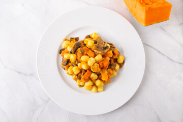 Gnocchi with pumpkin and mushrooms. Healthy and vegetarian autumn dish.