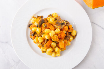 Gnocchi with pumpkin and mushrooms. Healthy and vegetarian autumn dish.