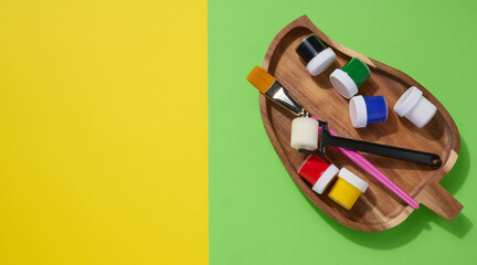 Plastic jars with multi-colored gouache, copy space