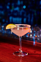 thirst quenching ice cold margarita cocktail with lime with bar background, concept
