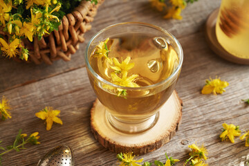 Fresh St. John's wort or Hypericum flowers in a cup of herbal tea