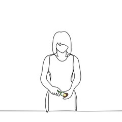 woman stands peeling potatoes with a vegetable peeler - one line art vector. concept peeling potatoes for cooking