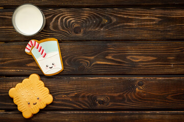 Funny cookies in shape of milk in glass and biscuit, top view