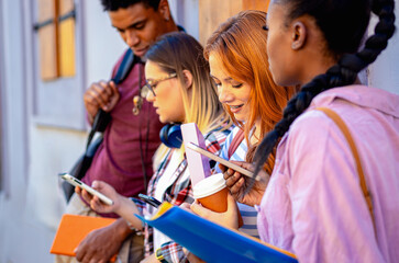 Fototapeta premium Diverse group of students standing and talking in city street.