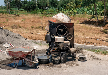 Concrete mixer machine located on the rice field road

