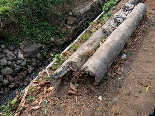 An electricity pole made of concrete is broken and unused
