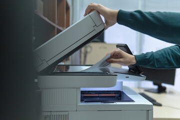 Businessman working in office, using photocopier with documents, business and work concept.