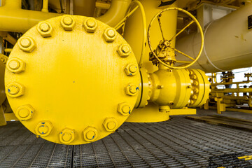 Oversized flange, large tube painted yellow with lots of bolts and nuts painted blue.