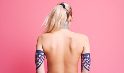 Bandana tattoo on rear bicep; woman from back with arm and neck tattoo, bleach blonde hair