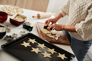 Unrecognizable woman preparing dough for gingerbread cookies
