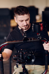 A professional videographer using modern equipment to capture compelling visuals, showcasing expertise and creativity in the art of video production.