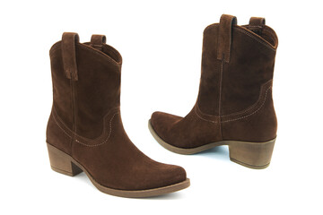 Pair of fashionable suede leather boots isolated on white background.