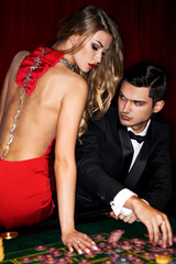 Beautiful young couple playing casino