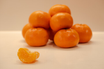 Several tangerine fruits on the table, healthy food and snacks, mandarin orange slices