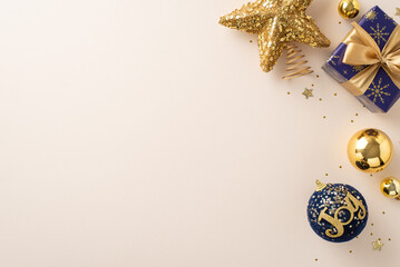 Seasonal dreams brought to life idea. Top view image of radiant decorations, blue giftbox with bow, star, shiny sequins on a neutral background with area for greeting text or advertising