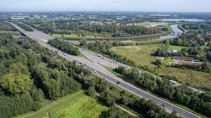 Mechelen, Antwerp Province, Belgium, 06 09 2023, Aerial view of the E19 highway between Brussels and Antwerp with traffic, high angle view. High quality photo