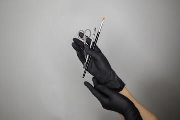 manicure master holding tools and equipment to make nails procedure