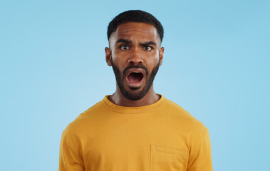 Face, surprise and man with gossip, news and announcement on a blue studio background. Portrait, person and model with shock, expression and mockup space with wow, omg and emoji with secret and icon - obrazy, fototapety, plakaty