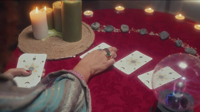 Female sorcerer doing tarot layout for client during future prediction session