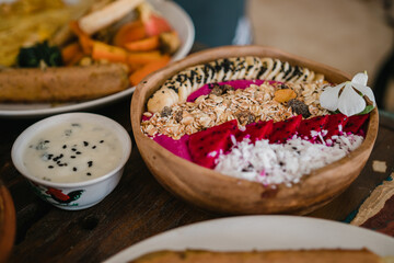 Healthy bowl of dragon fruit, banana, grains and seeds
