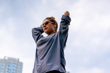 young street hip hop dancer in sportswear doing warm up before dance rehearsal hobby active lifestyle - obrazy, fototapety, plakaty