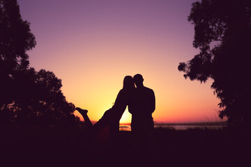 silhouette of a couple in love at sunset against a background of nature, there is a place for