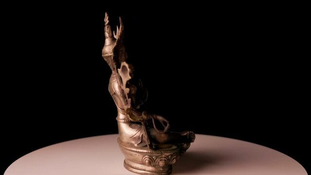 Close-up Guanyin Bodhisattva Statue on Black Background. She was given the name "Goddess of Mercy"