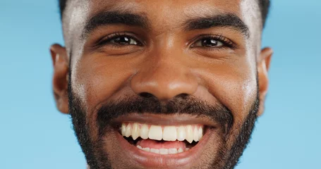 Fotobehang Happy, smile and face of black man in studio, blue background and mockup space with happiness or advertising. Portrait, closeup and marketing for skincare, wellness or healthy dermatology care © Wesley JvR/peopleimages.com