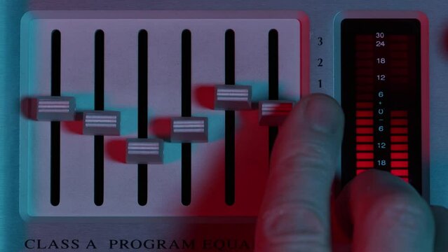 Recording studio equipment. Parametric eq being adjusted close up.