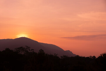 Silhouette of mountain forest at sunset. Hot weather. Climate change.