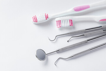Dental care concept, dentist tools and toothbrush on white background