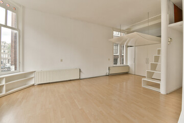 an empty living room with wood flooring and large windows looking out onto the cityscapearl area